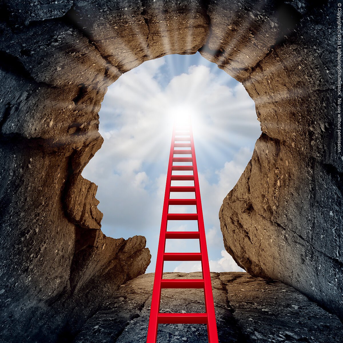 Concept of open mind as a a deep mountain cliff shaped as a human head with a ladder leading to the outside towards a glowing sun as a psychology and mental health metaphor for spiritual discovery.